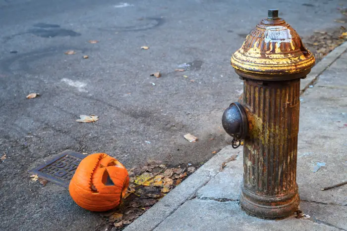 A photo of a pumpkin head on the street